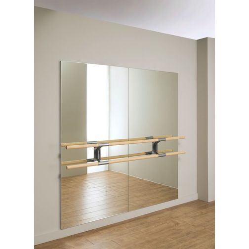 Wall mirror with cutout for ballet bar holder.